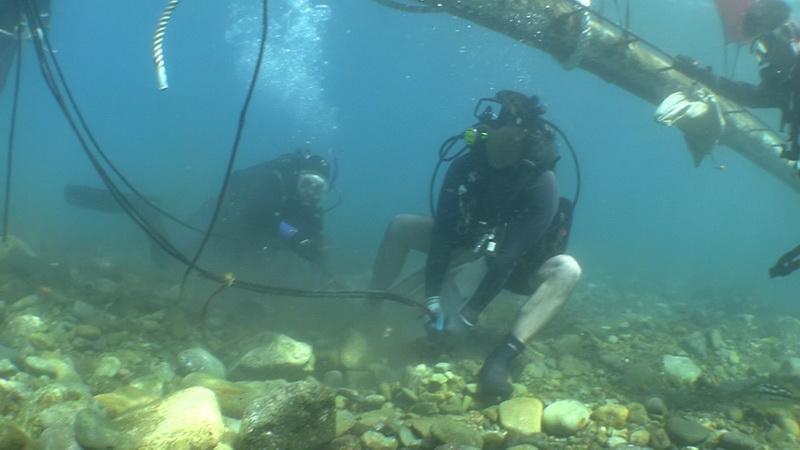 ODA Dive volunteer Jason Manix tugging on cable of sunken wreck Godspeed