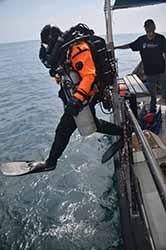 Volunteer rebreather diver Mike entering water