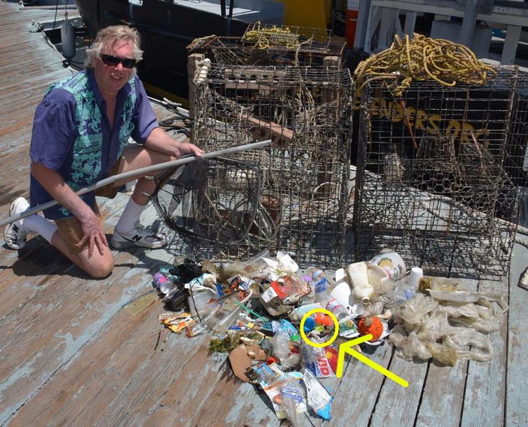 Ocean Defender Kurt Leiber with man-made debris, trash, and lobster traps that were hauled out of the ocean