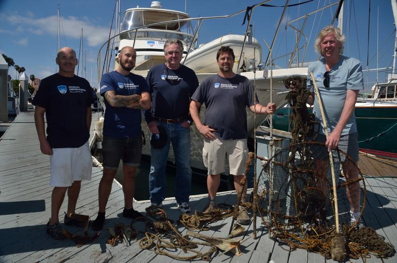 ODA Dive & Boat Crew with the days catch - marine debris including a lobster hoop net