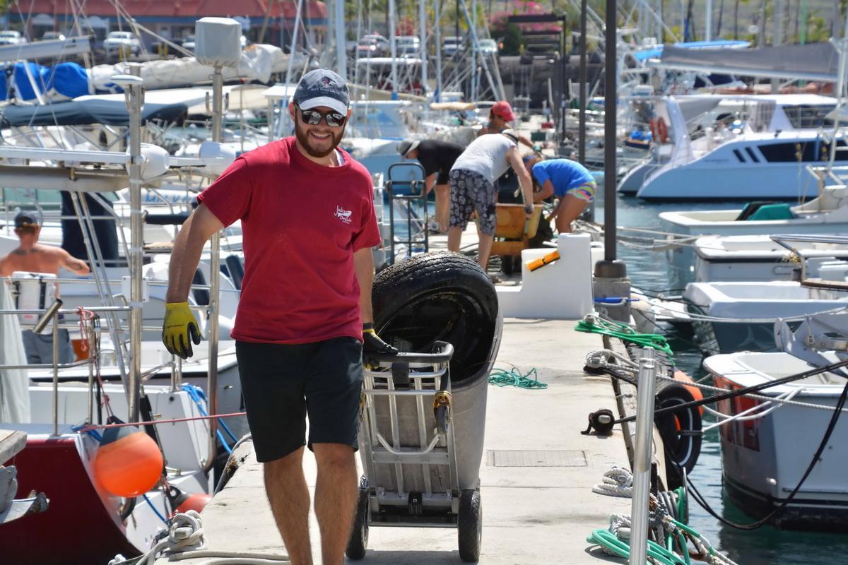 Volunteer removes tire from ocean
