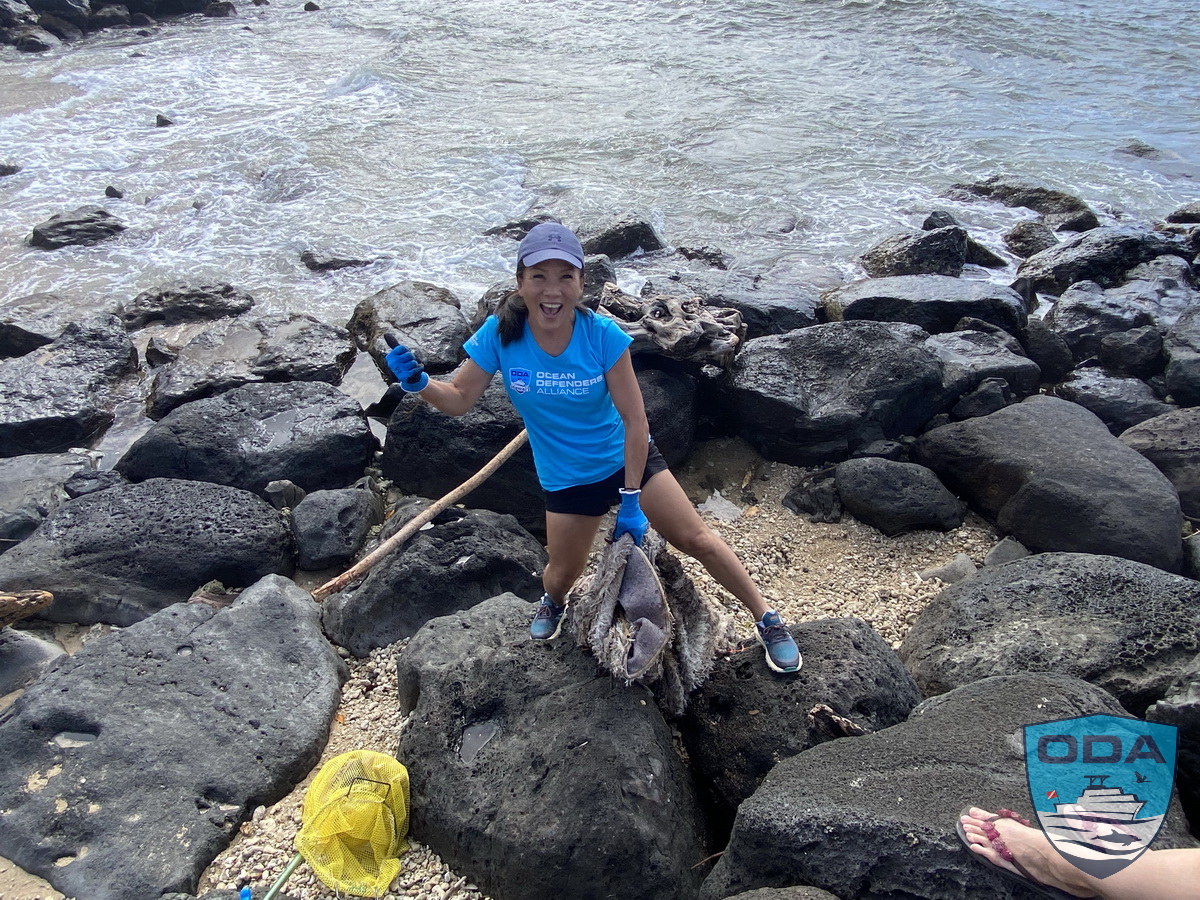 ODA Volunteer Rose removes trash from rocks