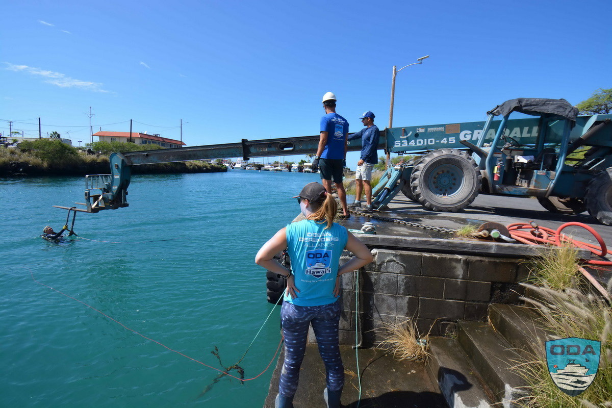 Diver attaches debris to Forklift