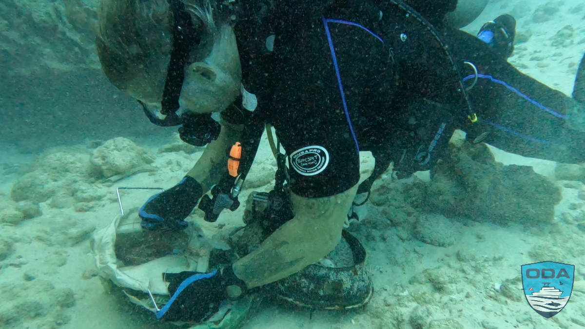 Diver fills bag with marine debris